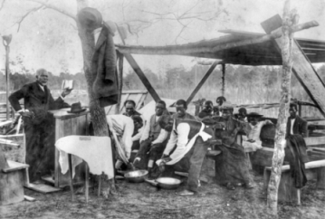 View of a foot washing ceremony at the Mount Ronius Free Will Baptist Church at Lake Waccamaw, ca. 1910. North Carolina Collection, University of North Carolina at Chapel Hill Library.